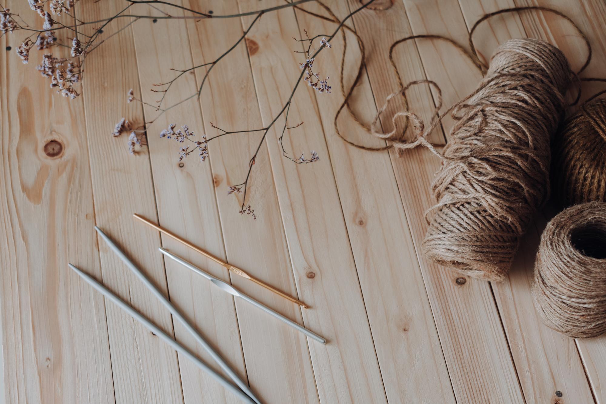 artisan sewing thread and needle on linen